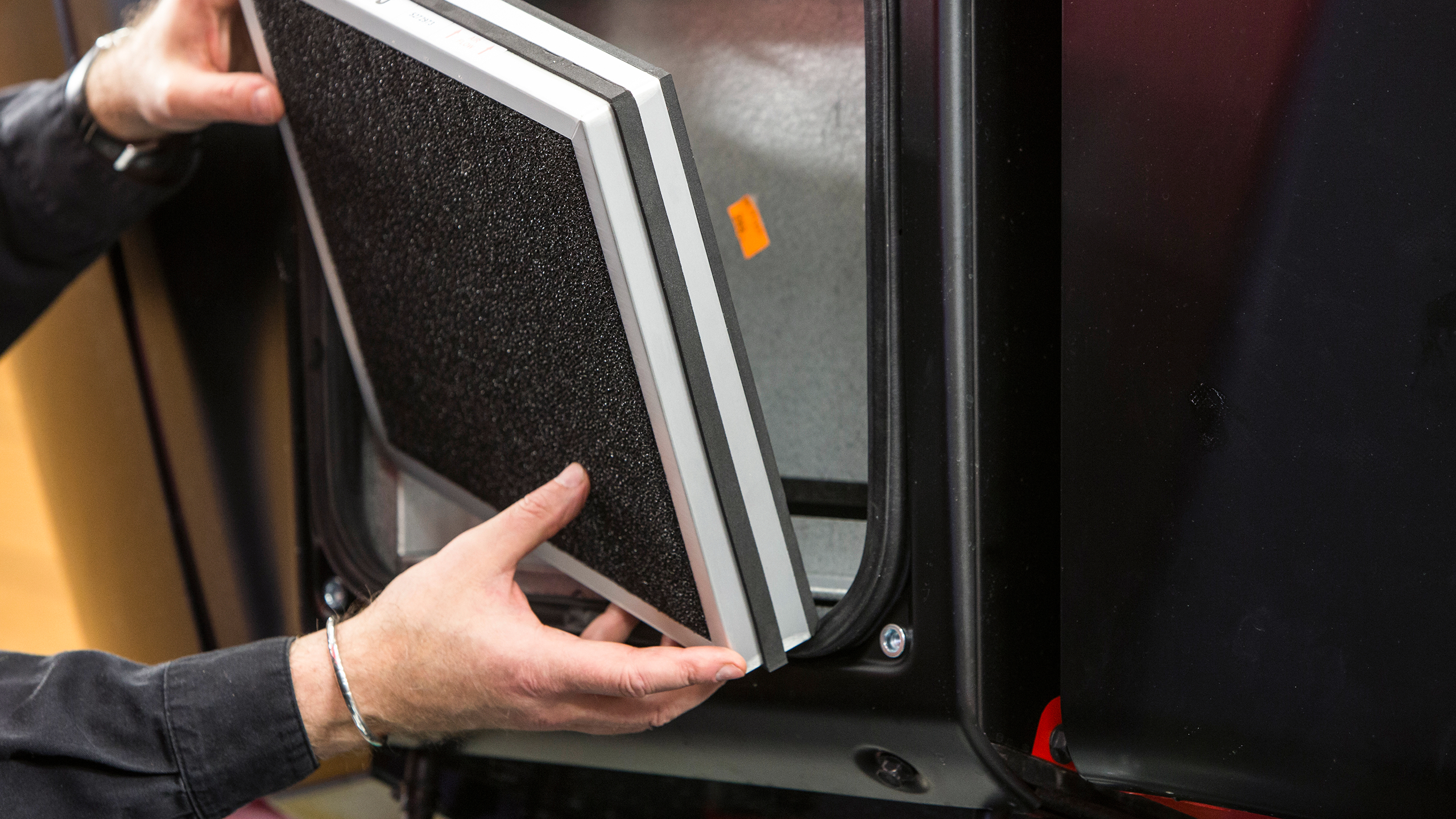 Hands putting filter on place