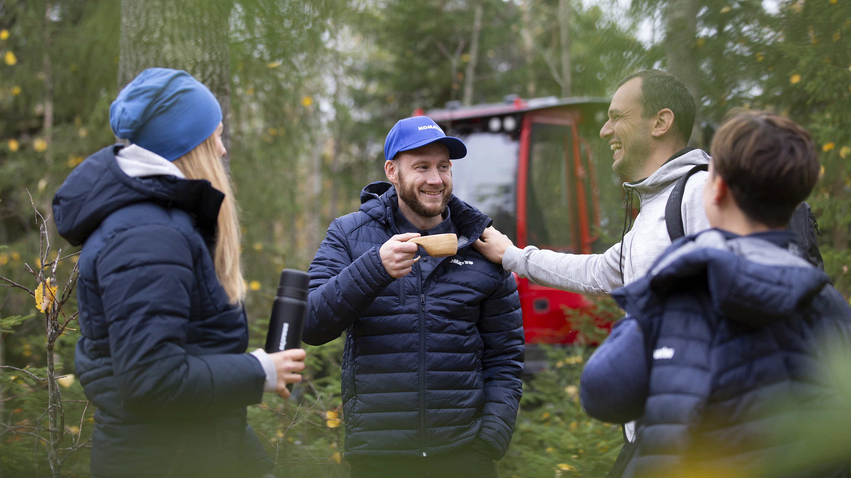 People gathering in frotn of Komatsu forest machine